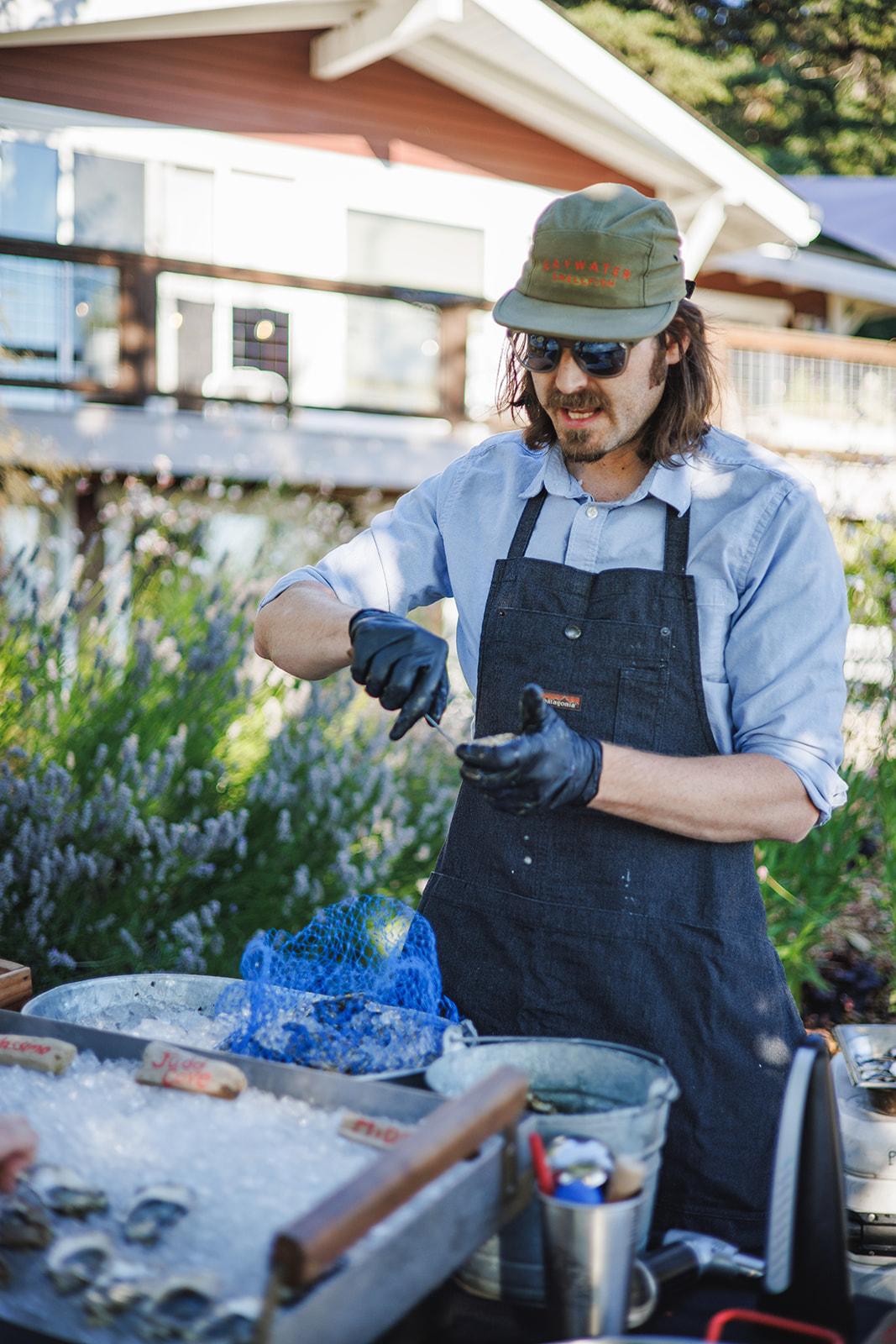 A caterer serving oysters on the farm
